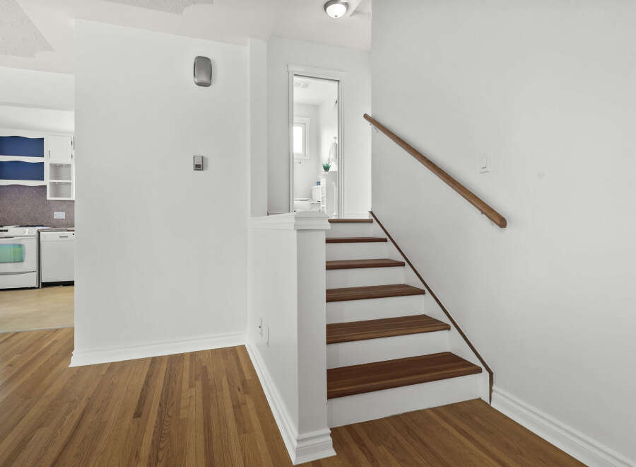 Step into this inviting home and discover a beautifully designed staircase leading to the upper levels.