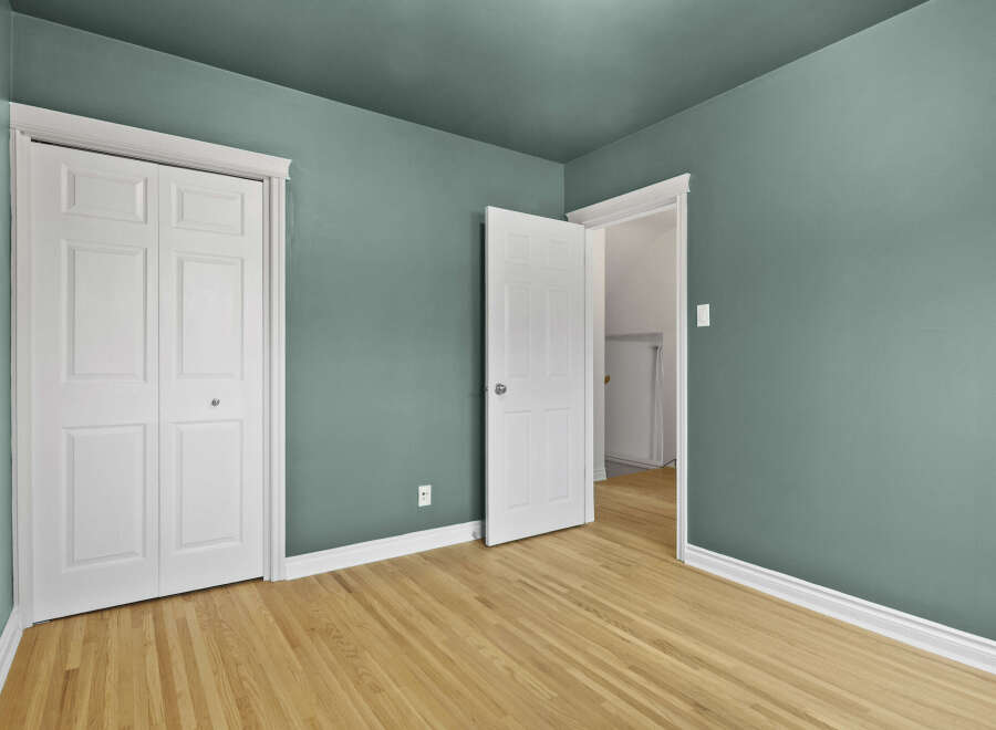 Step into this inviting room featuring a fresh coat of paint and beautiful hardwood floors.