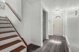 Step into this inviting entryway with a beautiful staircase and a welcoming front door.