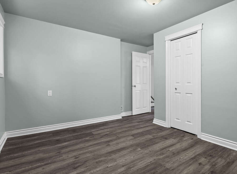 This inviting room features a neutral color palette, creating a serene and versatile space.