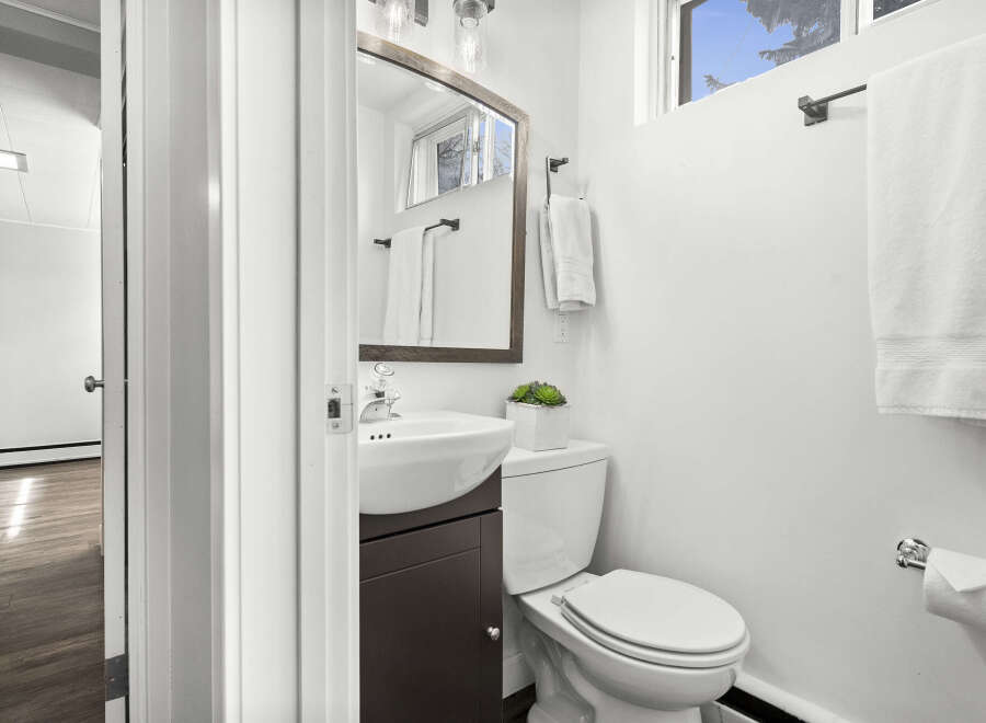 Step into this beautifully designed bathroom, featuring a modern sink and a sleek toilet.