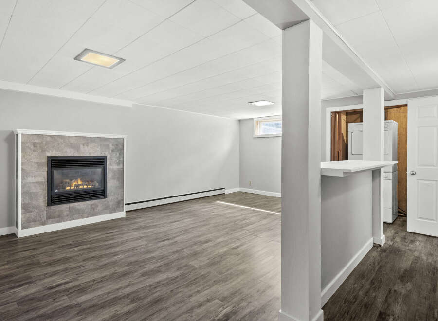 This inviting living space features a cozy fireplace, perfect for those chilly evenings.