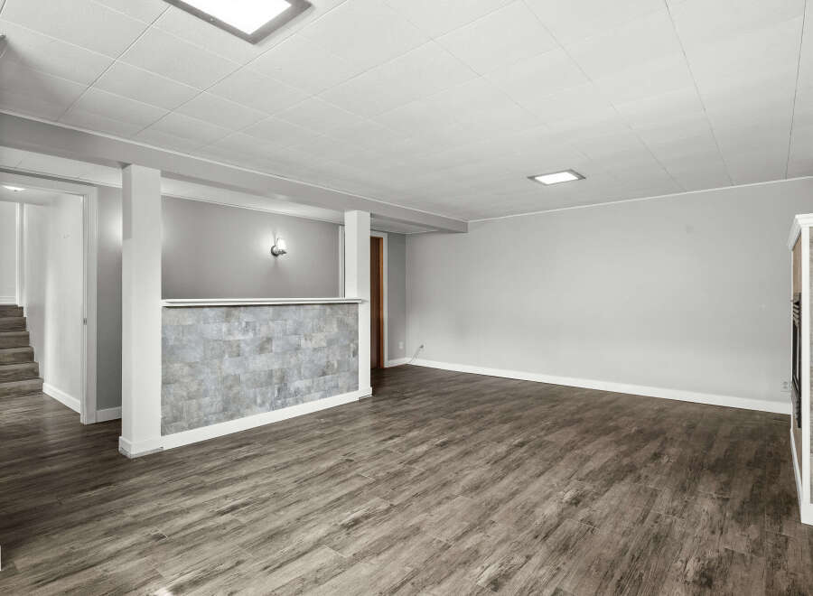 Discover the potential of this spacious property! Featuring a modern design with a stylish accent wall and sleek flooring, this space is ready for your personal touch.