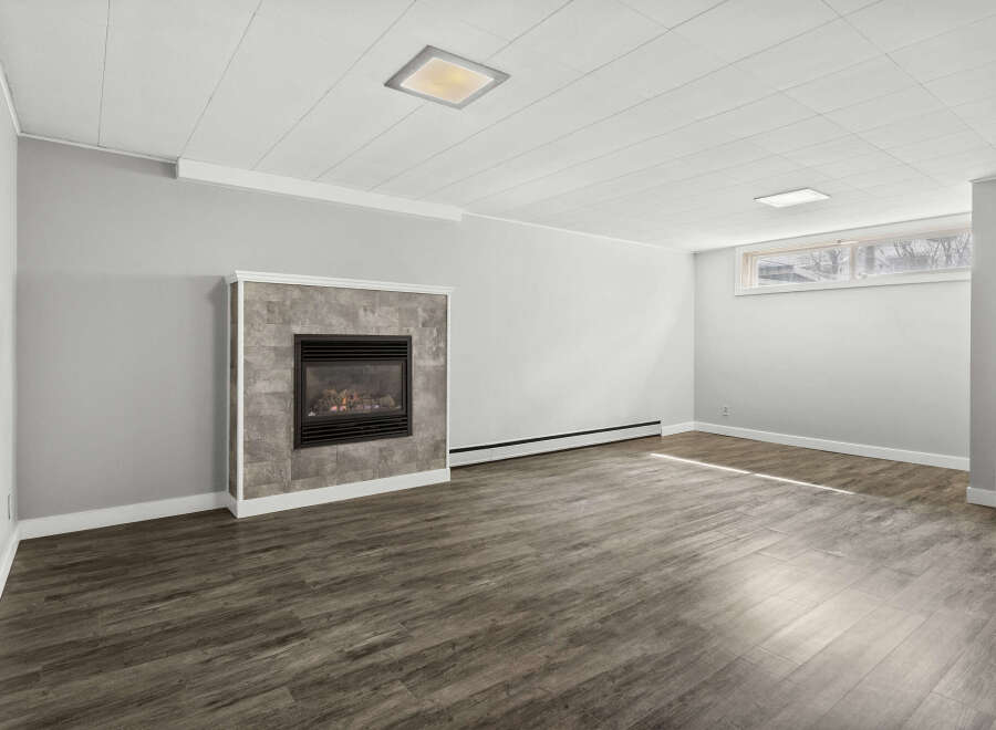 This inviting living space features a cozy fireplace, perfect for creating a warm and welcoming atmosphere.