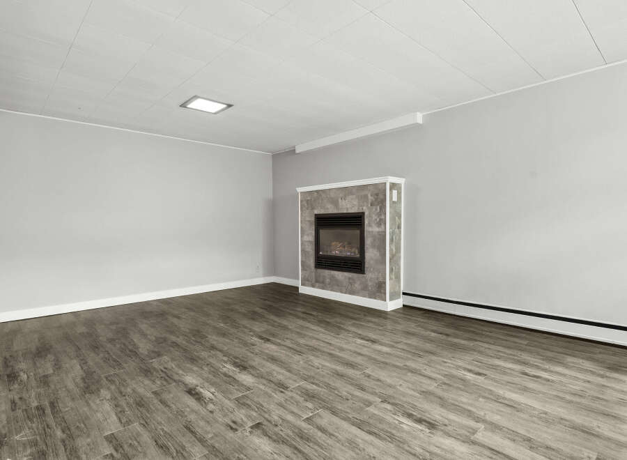 This inviting living space features a cozy fireplace, perfect for creating a warm and welcoming atmosphere.