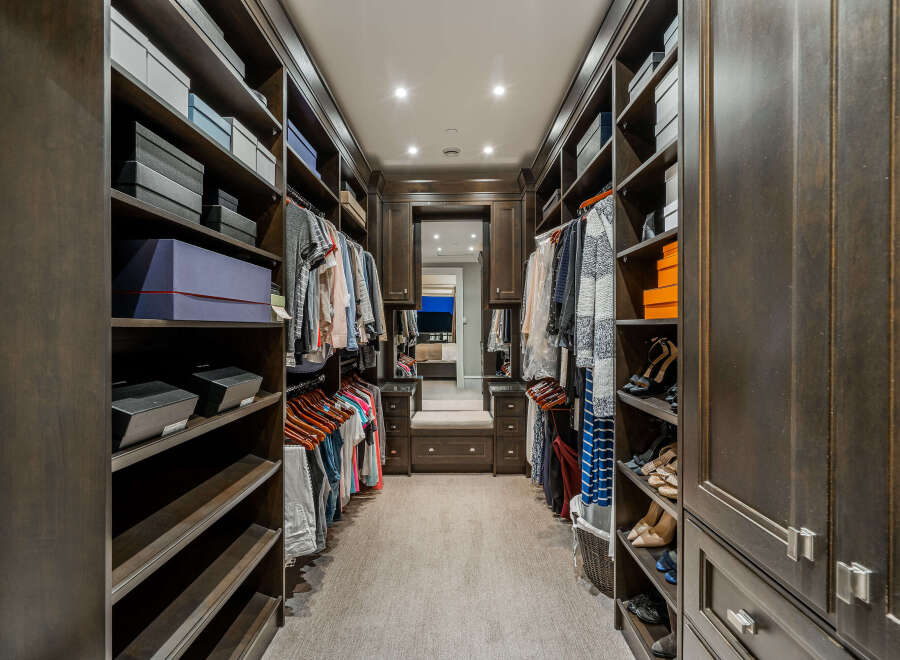 Step into luxury with this stunning walk-in closet, designed to maximize space and style.