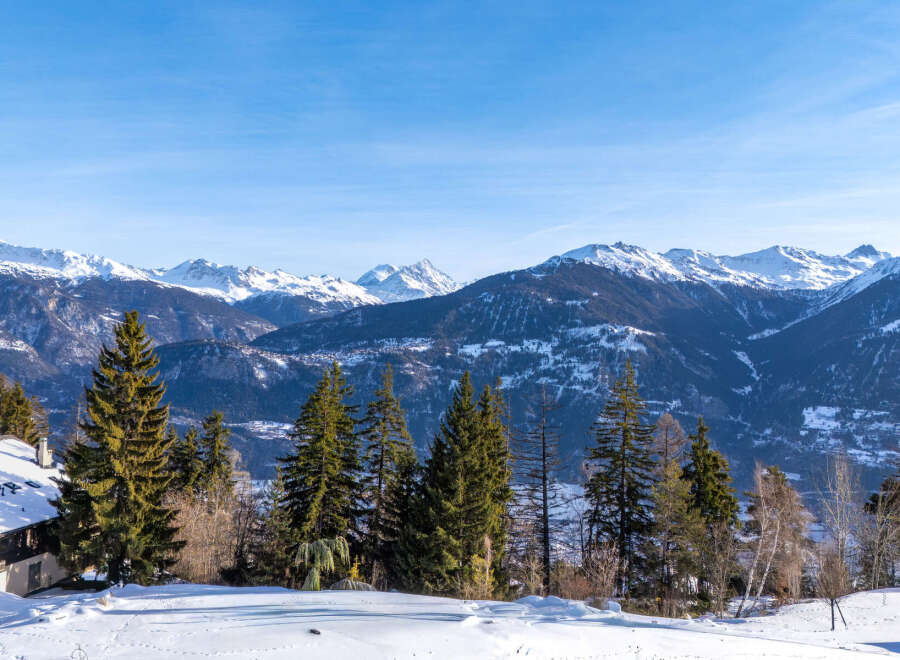 Experience the ultimate in alpine living with this stunning property, offering breathtaking views of snow-capped mountains.