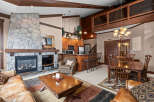 This stunning property boasts a cozy living room with a stone fireplace, perfect for relaxing evenings.