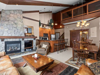 This stunning property boasts a cozy living room with a stone fireplace, perfect for relaxing evenings.