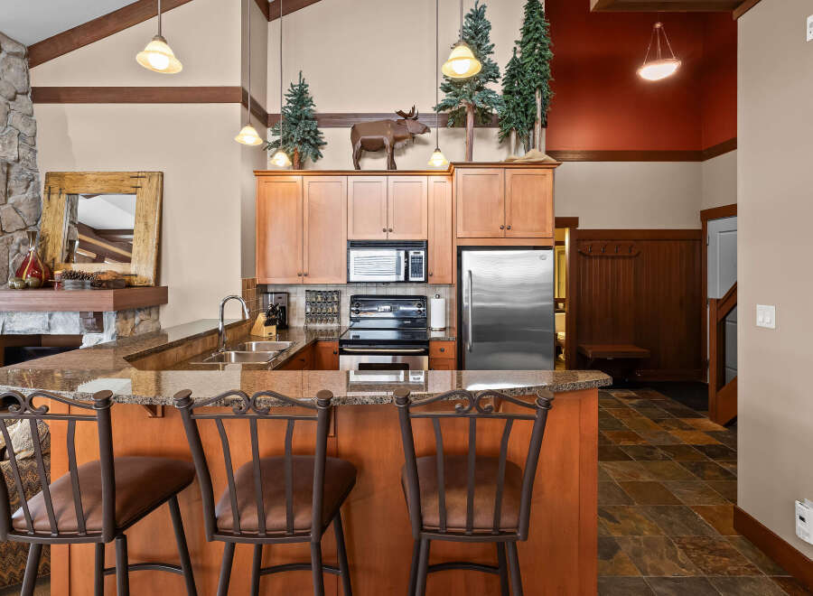 This stunning kitchen boasts a rustic charm with its wooden cabinetry and granite countertops.