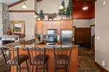This stunning kitchen boasts a rustic charm with its wooden cabinetry and granite countertops.