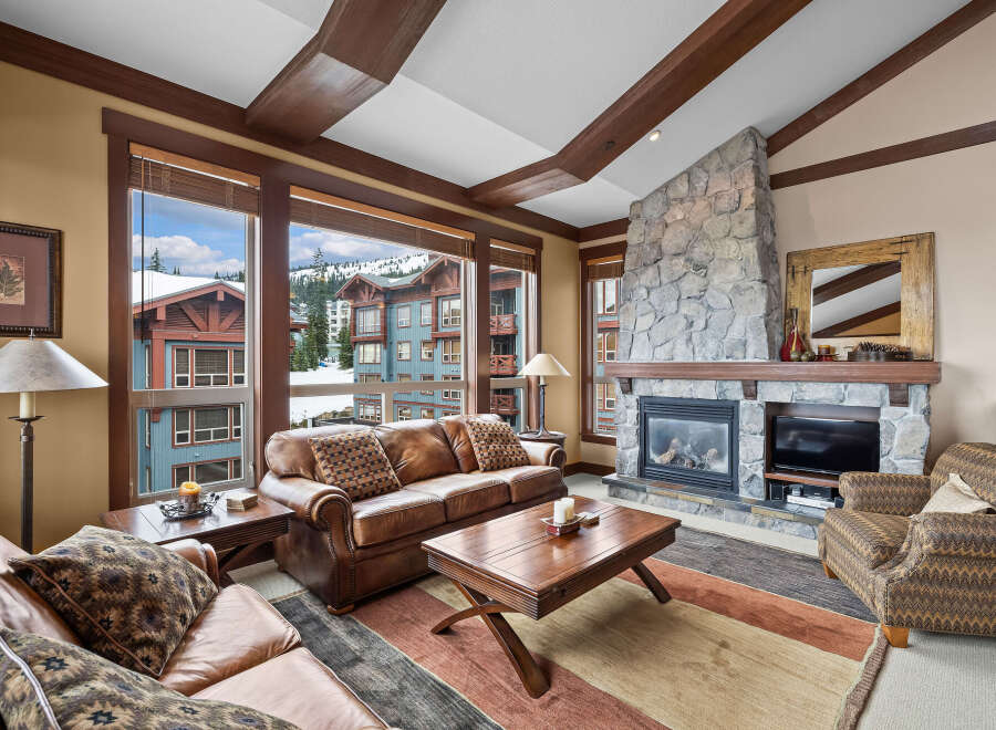 Experience luxury living in this stunning property featuring a cozy fireplace and expansive windows offering breathtaking views.