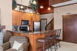 This stunning kitchen boasts beautiful wooden cabinetry and a sleek granite countertop, perfect for preparing meals and entertaining guests.