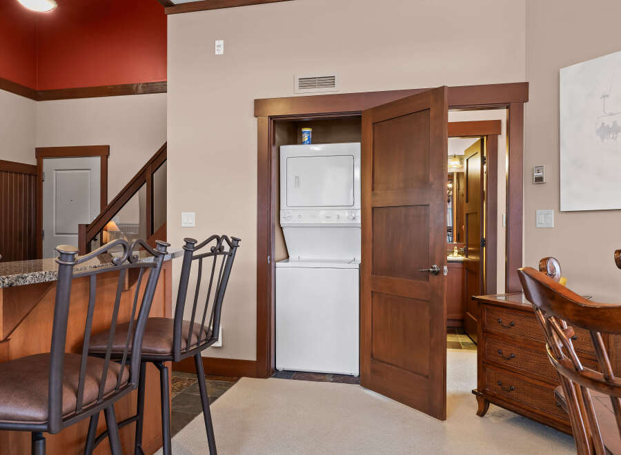 This stunning property boasts a modern kitchen with granite countertops and stylish bar stools, perfect for entertaining.
