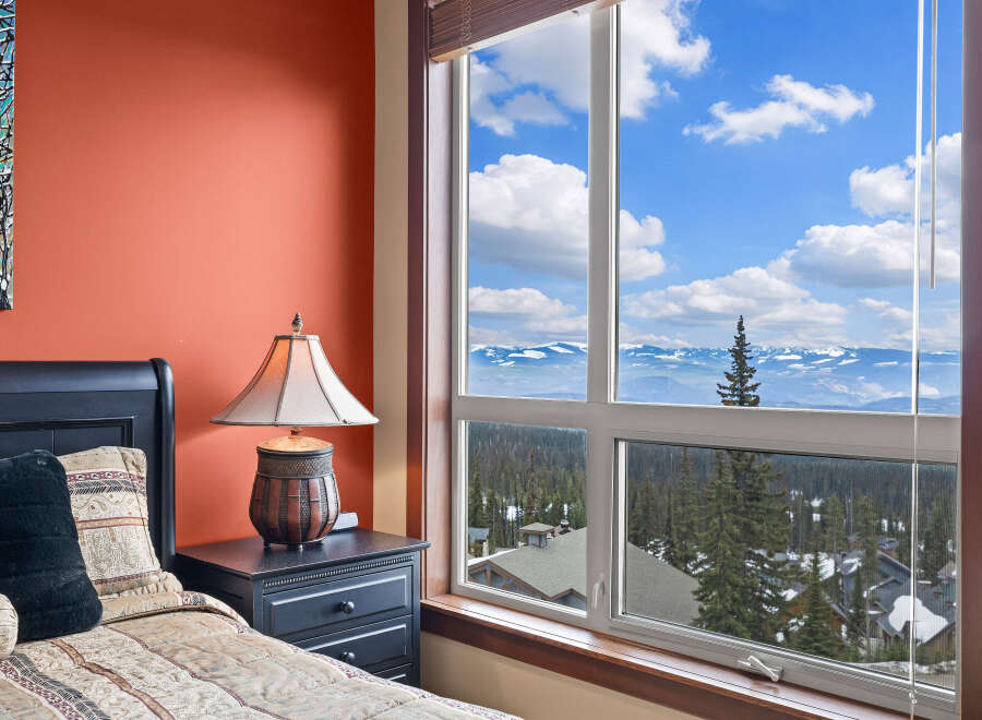 Enjoy breathtaking mountain views from this cozy bedroom.