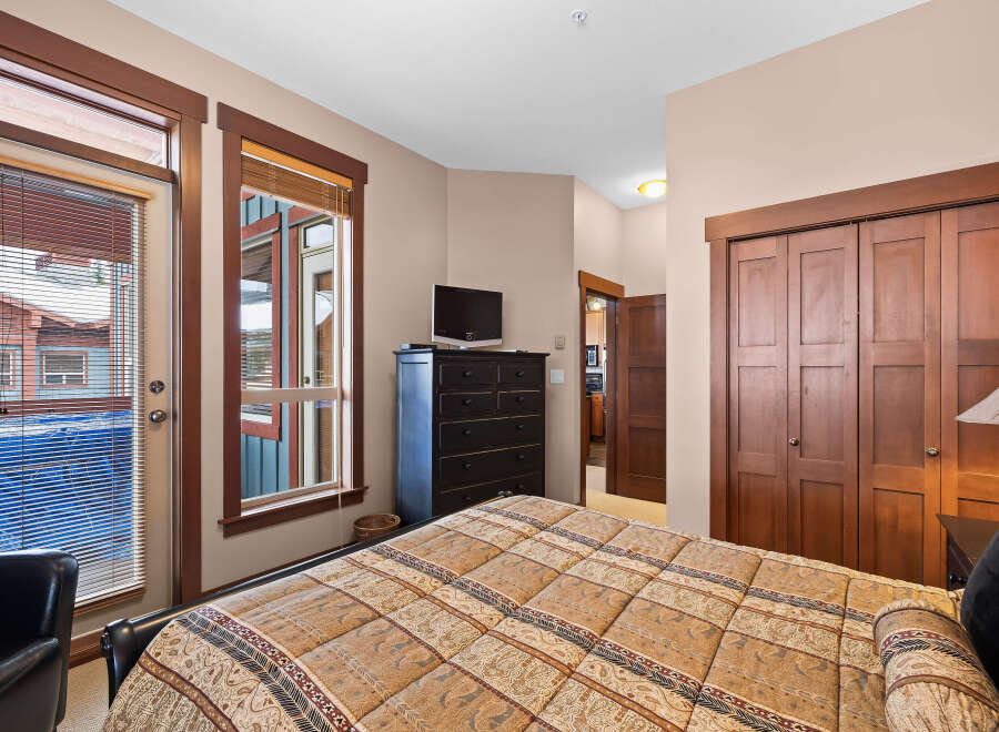 This inviting bedroom features a cozy bed with a patterned comforter, perfect for relaxation.