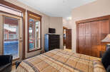 This inviting bedroom features a cozy bed with a patterned comforter, perfect for relaxation.