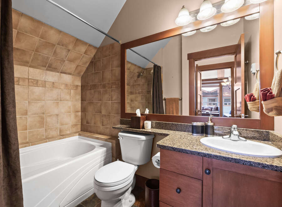 This stunning bathroom features a luxurious bathtub and a modern vanity, perfect for relaxation and daily routines.