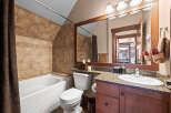 This stunning bathroom features a luxurious bathtub and a modern vanity, perfect for relaxation and daily routines.