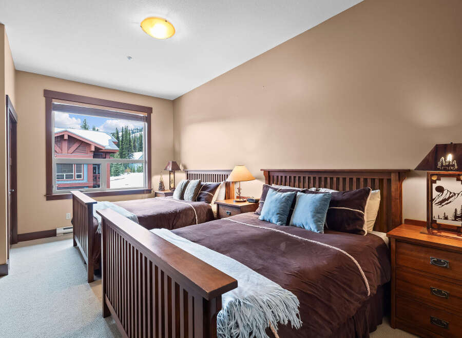 This cozy bedroom features two comfortable beds, perfect for a relaxing stay.