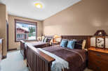 This cozy bedroom features two comfortable beds, perfect for a relaxing stay.