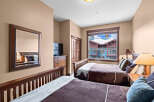 This cozy bedroom features two comfortable beds with plush bedding, perfect for a relaxing stay.