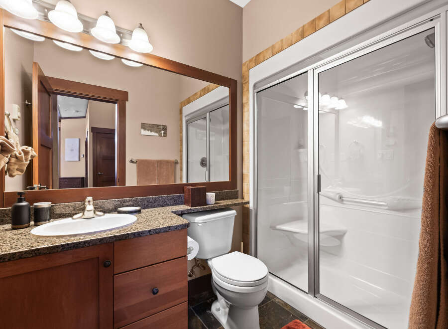This stunning bathroom boasts a modern design with a spacious walk-in shower and a sleek vanity.