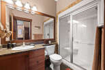 This stunning bathroom boasts a modern design with a spacious walk-in shower and a sleek vanity.