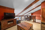This stunning property boasts a spacious living area with a modern entertainment center and a cozy seating area.