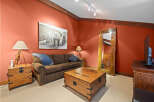 This cozy living room features a comfortable brown sofa, perfect for relaxing after a long day.