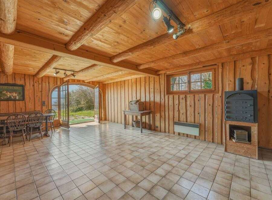 Step into a rustic haven with this charming property, featuring a warm and inviting interior.