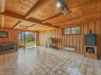 Step into a rustic haven with this charming property, featuring a warm and inviting interior.