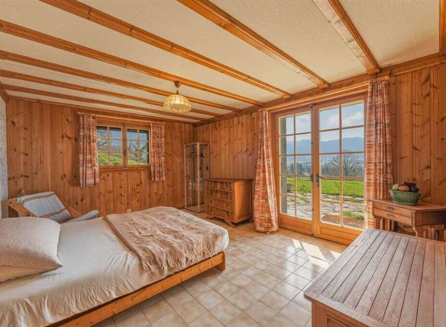 This charming bedroom features a cozy wooden interior, creating a warm and inviting atmosphere.
