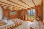 This charming bedroom features a cozy wooden interior, creating a warm and inviting atmosphere.