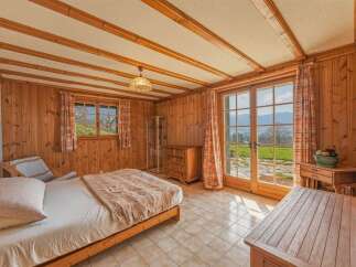 This charming bedroom features a cozy wooden interior, creating a warm and inviting atmosphere.