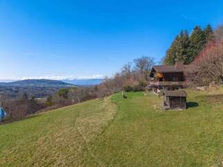 Nestled on a hillside, this charming property offers breathtaking views and a tranquil escape.