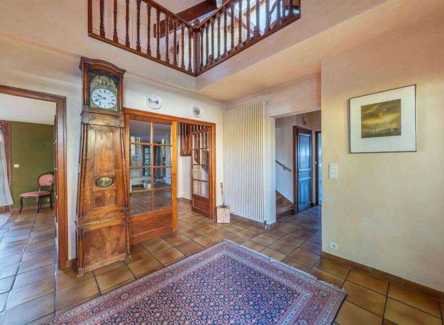 Step into this inviting home and be greeted by a grand entrance featuring a stunning grandfather clock and a beautiful rug.