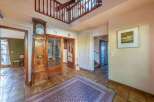Step into this inviting home and be greeted by a grand entrance featuring a stunning grandfather clock and a beautiful rug.
