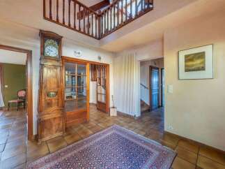 Step into this inviting home and be greeted by a grand entrance featuring a stunning grandfather clock and a beautiful rug.