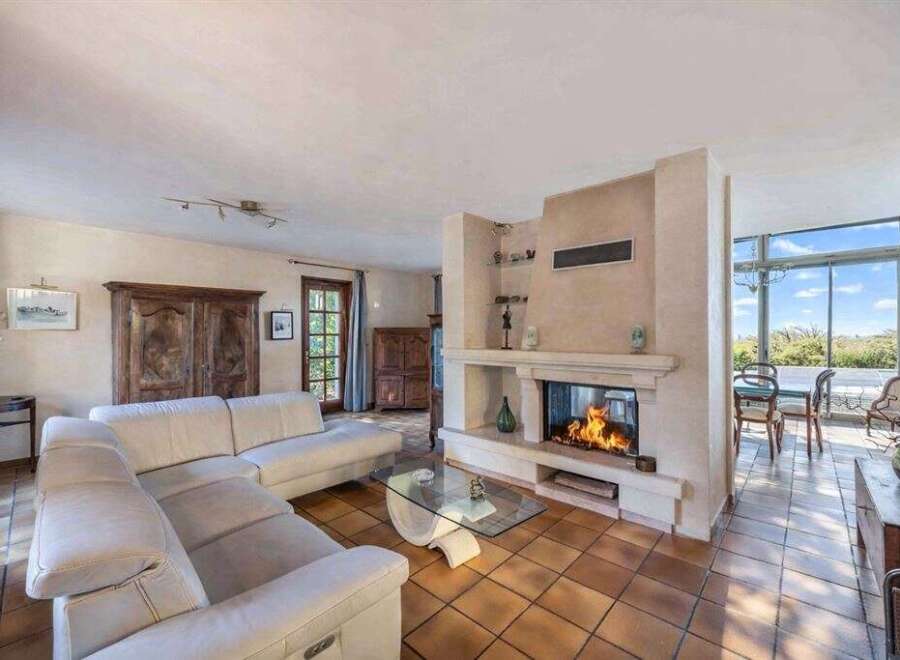 Experience the warmth of this inviting living space, featuring a cozy fireplace and a comfortable sectional sofa.