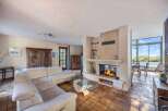 Experience the warmth of this inviting living space, featuring a cozy fireplace and a comfortable sectional sofa.