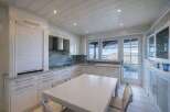 This stunning kitchen boasts a bright and airy design, perfect for culinary enthusiasts.