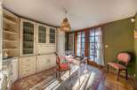 Step into this charming home office, featuring a classic design with built-in cabinetry and a cozy ambiance.