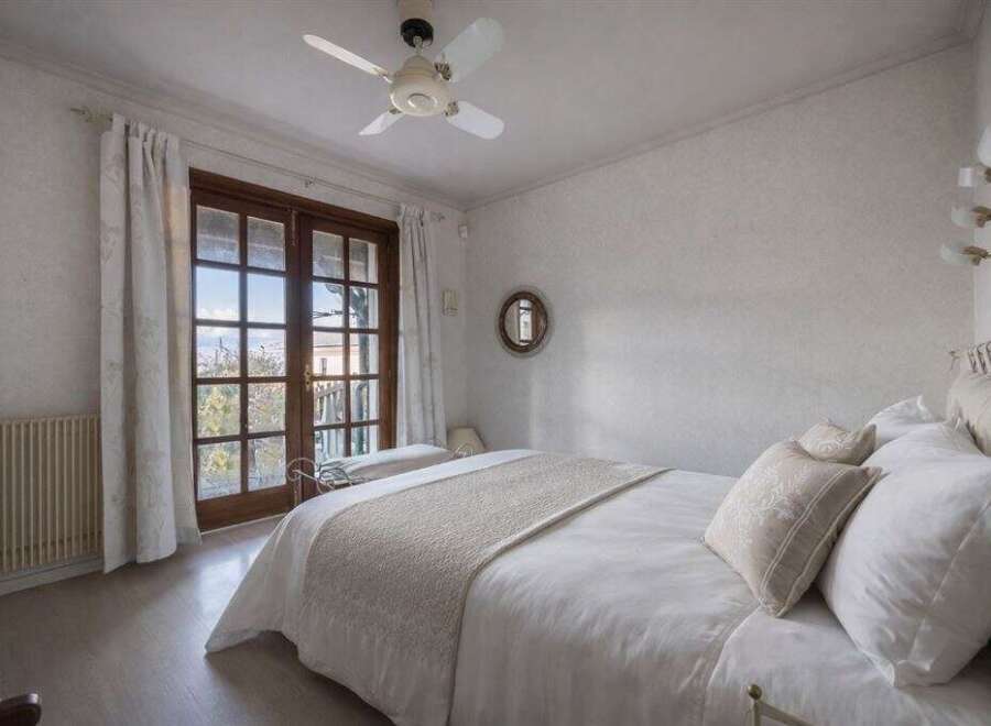 This charming bedroom features a cozy ambiance with its soft color palette and natural light.