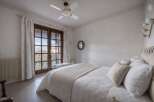 This charming bedroom features a cozy ambiance with its soft color palette and natural light.