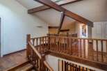 This stunning property boasts a beautifully crafted wooden staircase and railing, adding a touch of elegance to the interior.