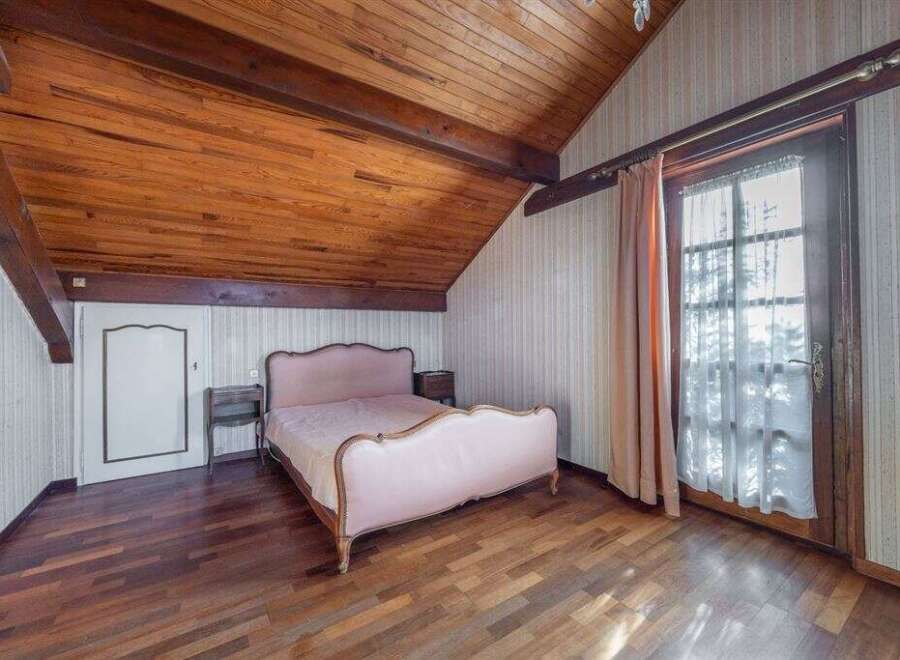 Discover the charm of this unique bedroom featuring a stunning wooden ceiling and floors.