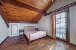 Discover the charm of this unique bedroom featuring a stunning wooden ceiling and floors.