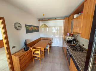 This charming kitchen offers a cozy dining area, perfect for enjoying meals.