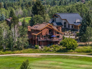 Nestled amidst lush greenery, this stunning property boasts a luxurious design with multiple levels and expansive decks.